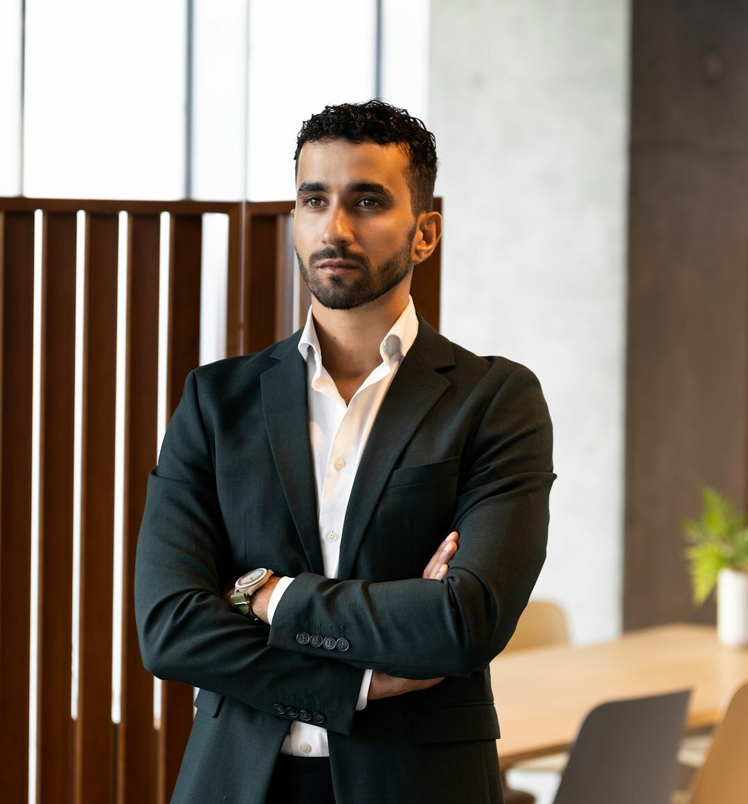 Confident professional Norwegian man in business attire presenting directly at camera