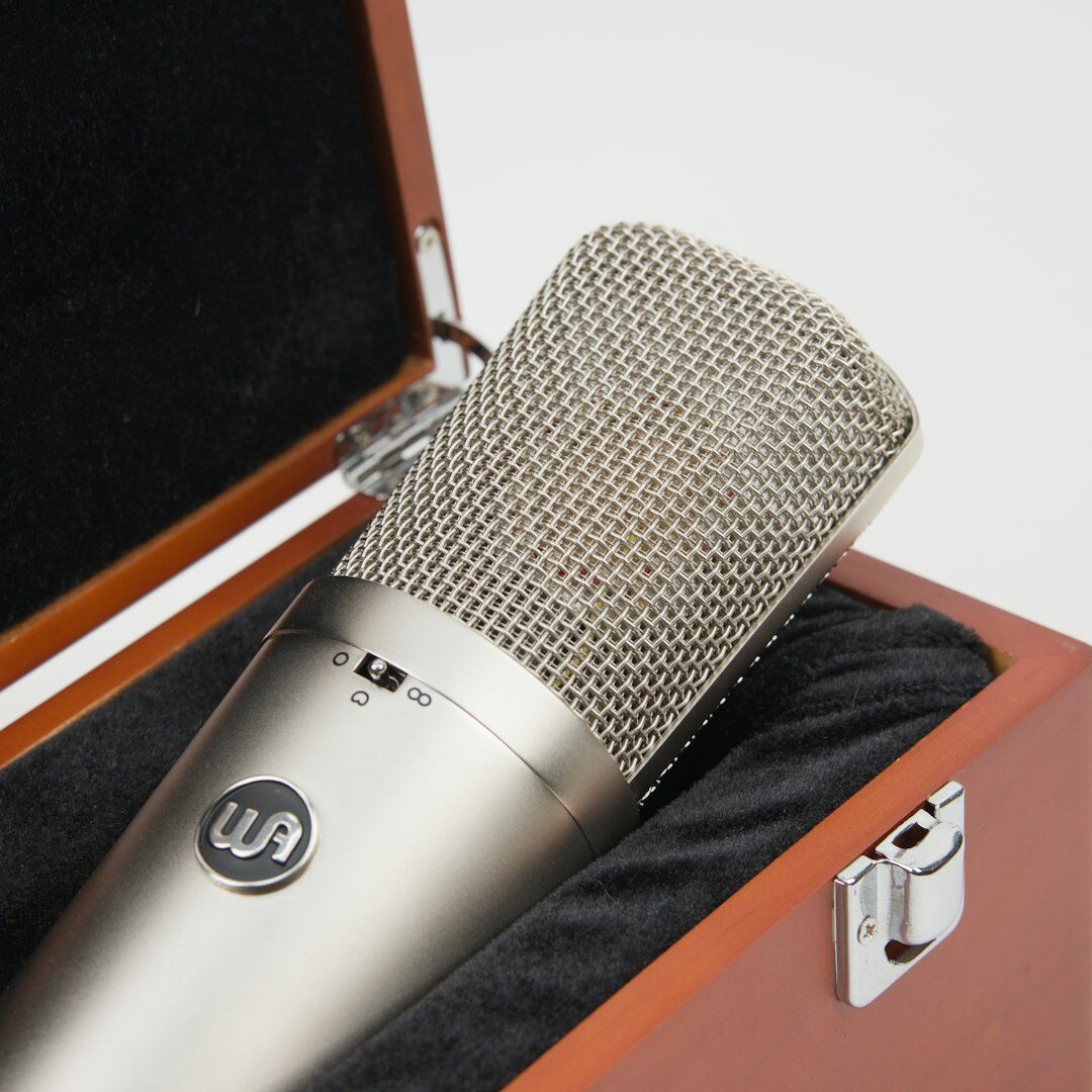 Close-up of a professional condenser microphone in a recording studio