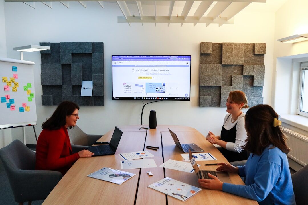 Two media professionals having a strategy discussion in a modern meeting room