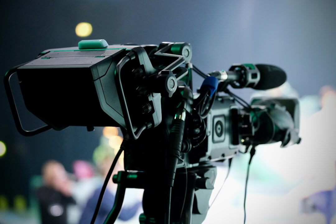Modern TV news studio set with teleprompter and broadcast lighting